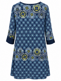 Back of Sugar Crisp SC03013 navy and lime floral print tunic with large floral bands across the shoulders and lower body, and plain navy cuffs.