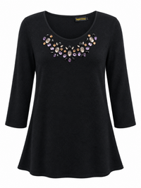 Front of black longline tunic with scoop neckline and colourful faceted jewel embellishment